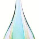 Close-up of the teal and green glass layers inside the clear teardrop