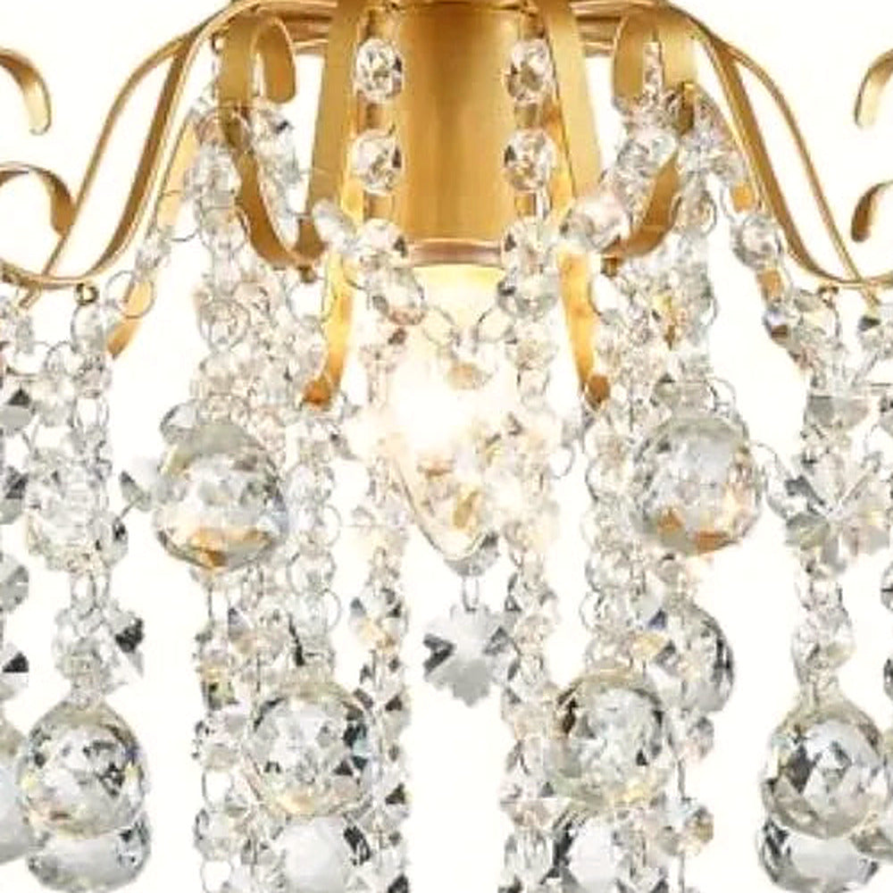 Close-up of cascading crystal strands on the gold flush mount