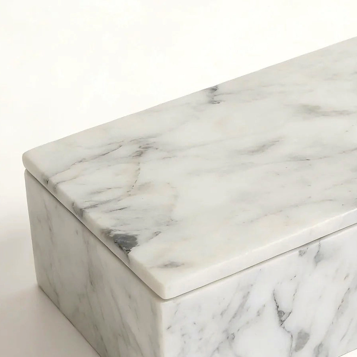 Close-up of the grey Carrara veining and crisp corner of the marble vanity box