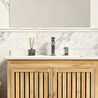 Detail of the white ceramic sink top on the bamboo vanity