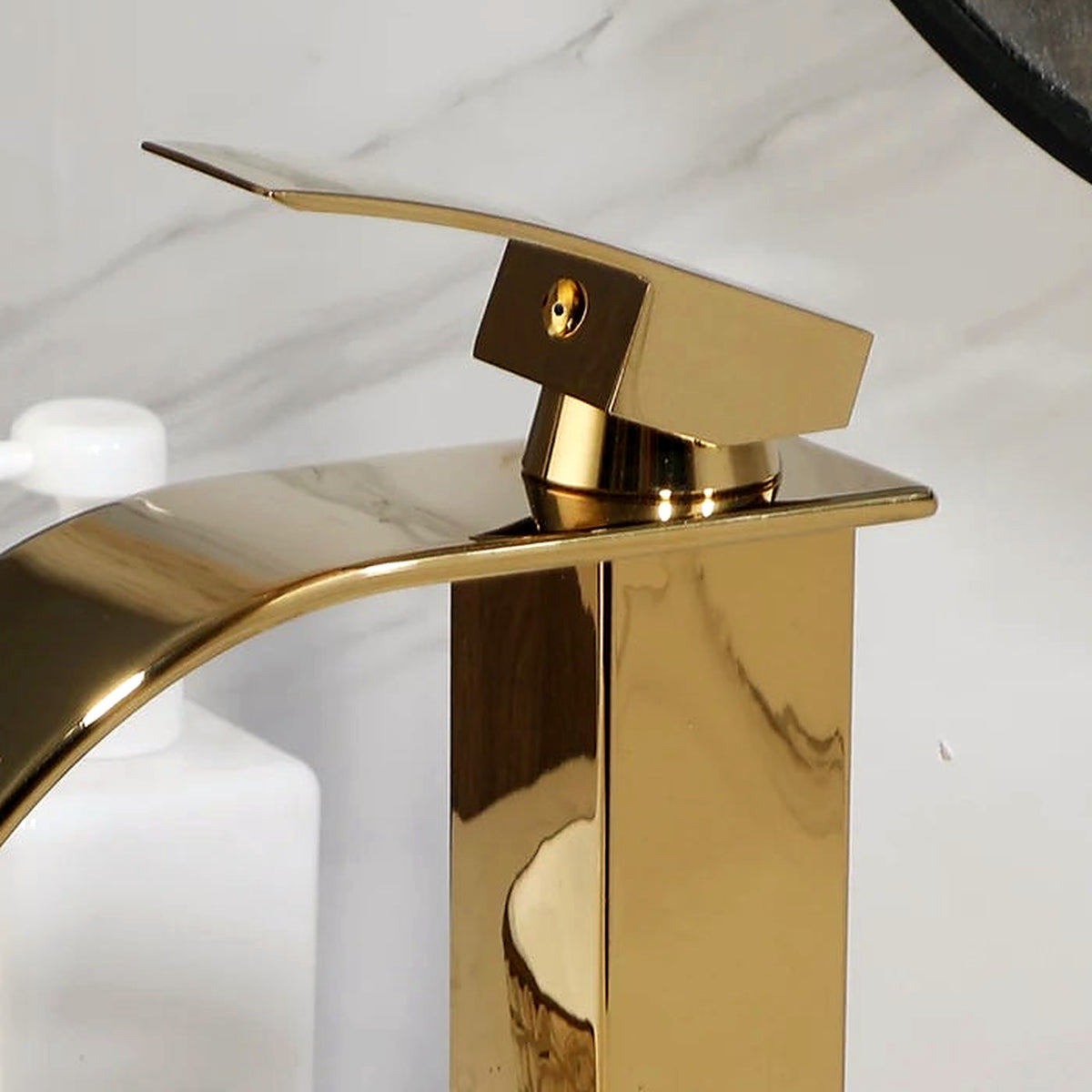 Detail of the polished gold waterfall faucet included with the vessel sink set