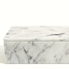 Detail of the polished white marble lid edge and natural grey veins