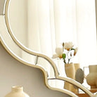 Detail of the curved gold rim and inset beveled glass