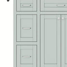 Detail of the stacked side drawers and silver bar pulls in mint green