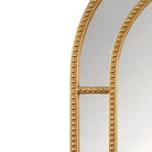 Detail of the nested mirrored side panels and beaded gold bars
