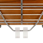 Detail of the folding chrome support mechanism under the teak seat