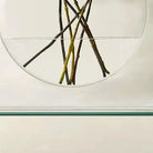 Detail of the flat glass base supporting the ellipse vase