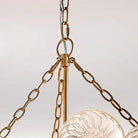 Detail of the brushed gold chains and central stem above the glass bubble cluster