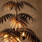 Detail of overlapping bronze palm fronds on the mid-tier of the pendant chandelier