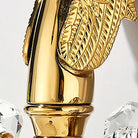Detail of the sculpted gold swan wing and feathered neck of the basin faucet