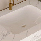 Detail of the grey-veined marble-look countertop and integrated sink