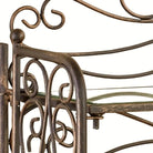Close-up of the side scrollwork and clear glass shelf in antique bronze with gold highlights