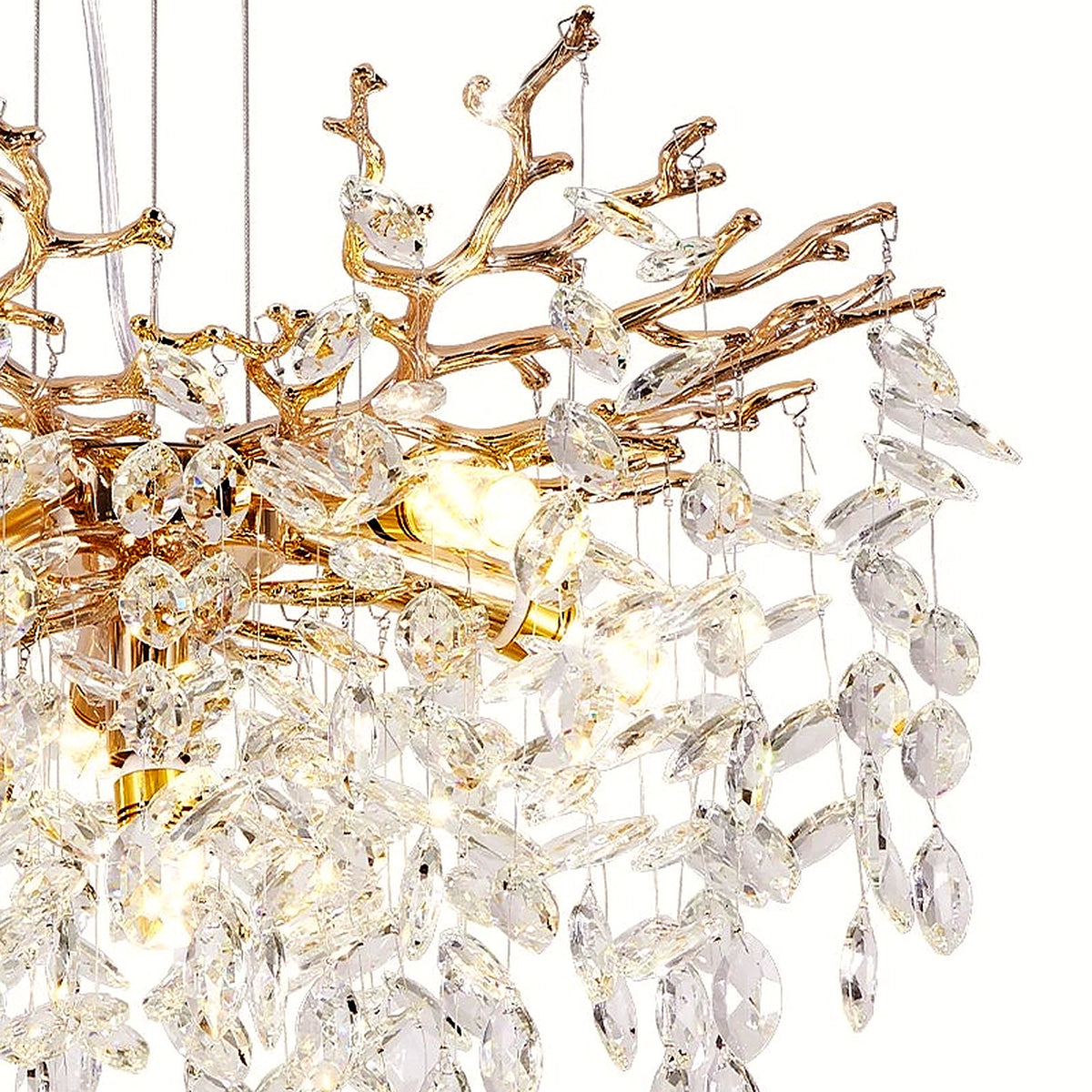 Close-up of almond-shaped faceted crystals and gold branch tips on the right side of the chandelier