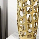 Detail of the sculpted gold lattice and lustrous mirror-like finish at the vase's base