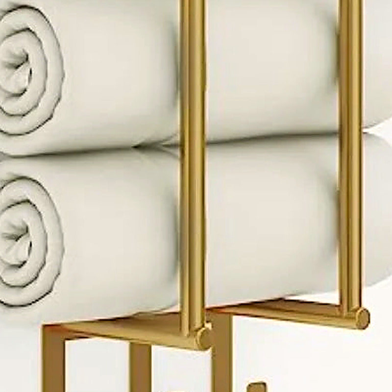 Close-up of rolled towels held in the brushed gold vertical rack