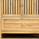 Close-up of the bamboo drawer front and round gold knob