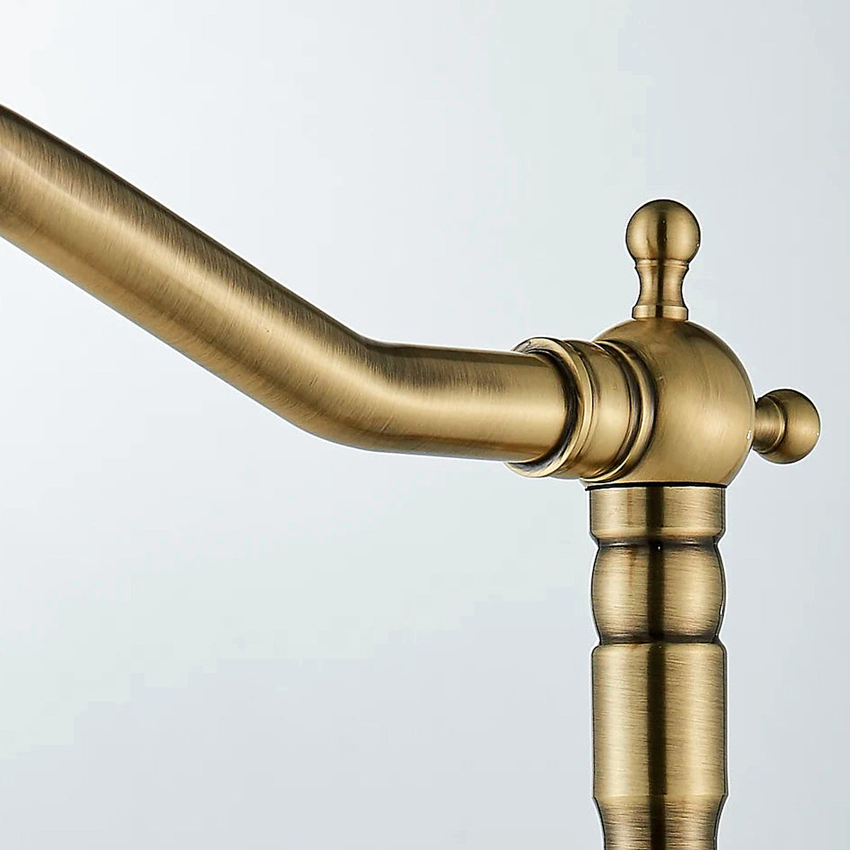 Close-up of the gooseneck spout tip and aerator in carved antique brass