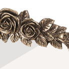 Close-up of the right-hand floral scrollwork on the antique brass arched mirror crest