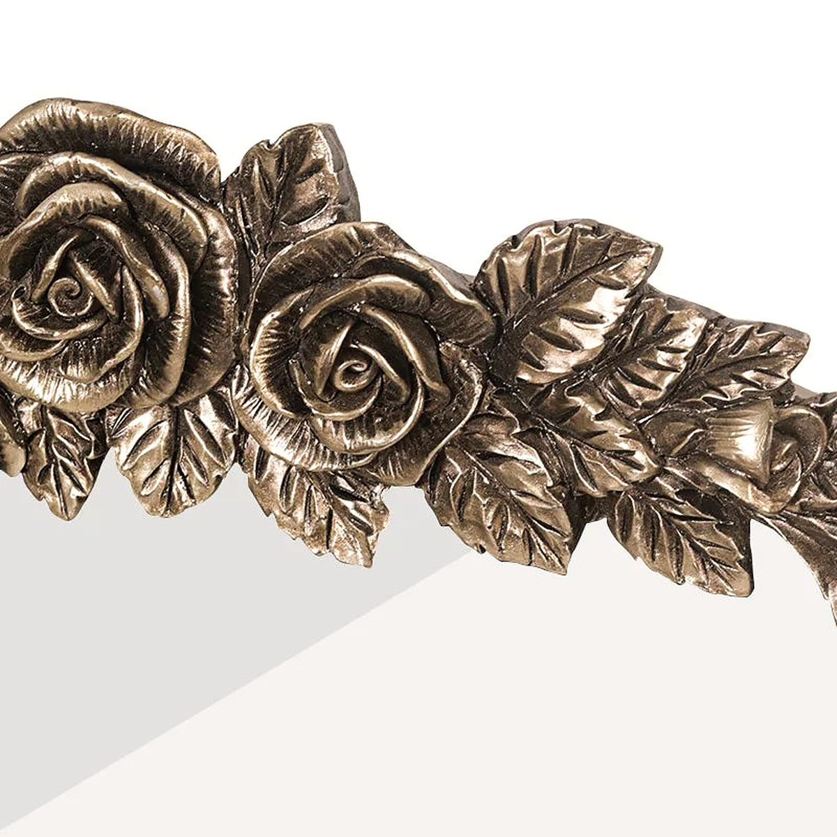 Close-up of the right-hand floral scrollwork on the antique brass arched mirror crest