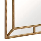 Close-up of the mitered gold-beaded corner and frame depth of the rectangular mirror