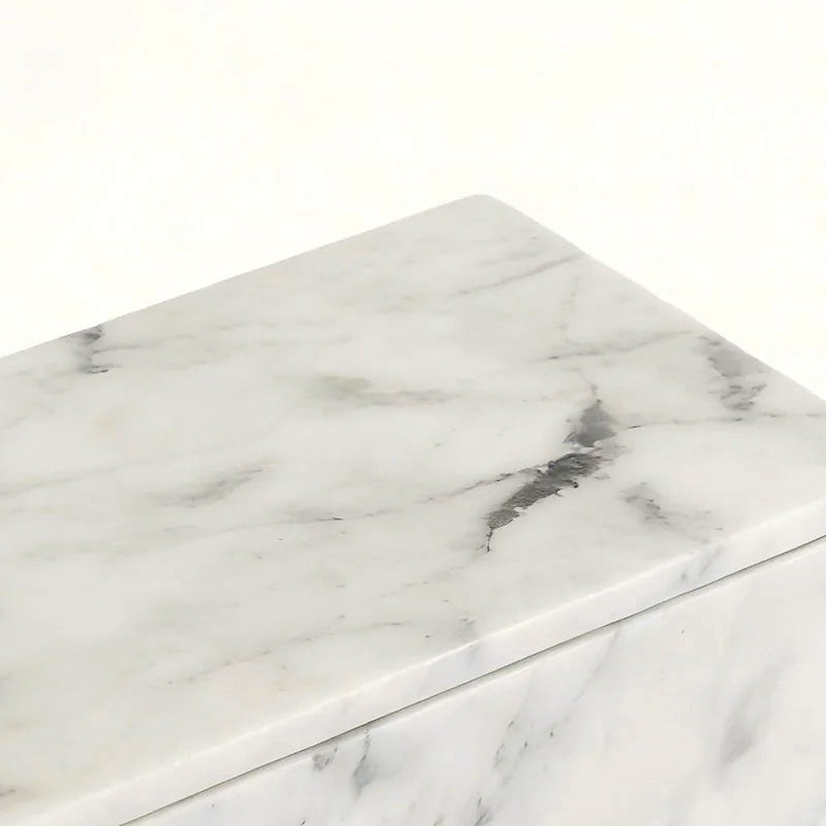Close-up of the front face of the Carrara white marble box showing dense grey marbling