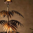 Close-up of the bronze canopy, chain and uppermost palm fronds of the pendant