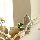Close-up of the gold frame edge meeting the mirrored surface