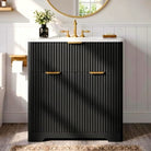 Black fluted bathroom vanity with ceramic sink, 30 in, and brushed gold bar pulls (faucet and mirror shown for styling)