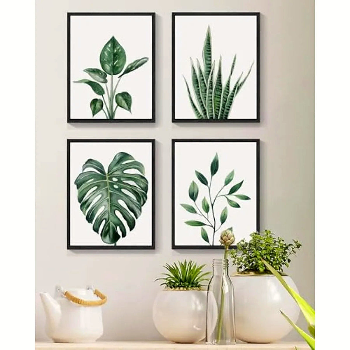Tropical leaf framed canvas wall art, set of four black frames in a 2x2 grid (ceramics shown for styling)