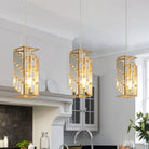 Gold crystal prism pendant lights, set of three, hanging over a white kitchen counter