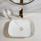 Polished gold waterfall faucet pouring into the hammered gold ceramic vessel sink