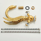 Gold swan-neck faucet body, crystal handles, supply lines and mounting hardware laid out for installation