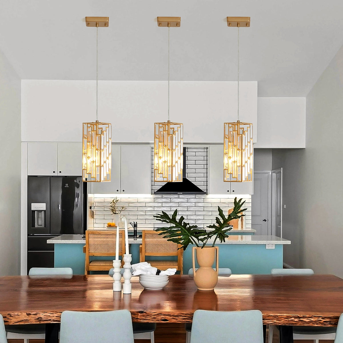 Three gold-framed crystal prism pendants above a live-edge dining table (furniture and décor shown for styling)