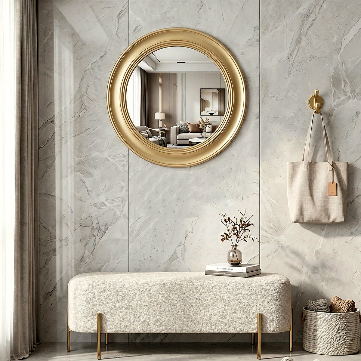 Brushed gold round wall mirror in an entryway above a cream bench (furniture and décor shown for styling)