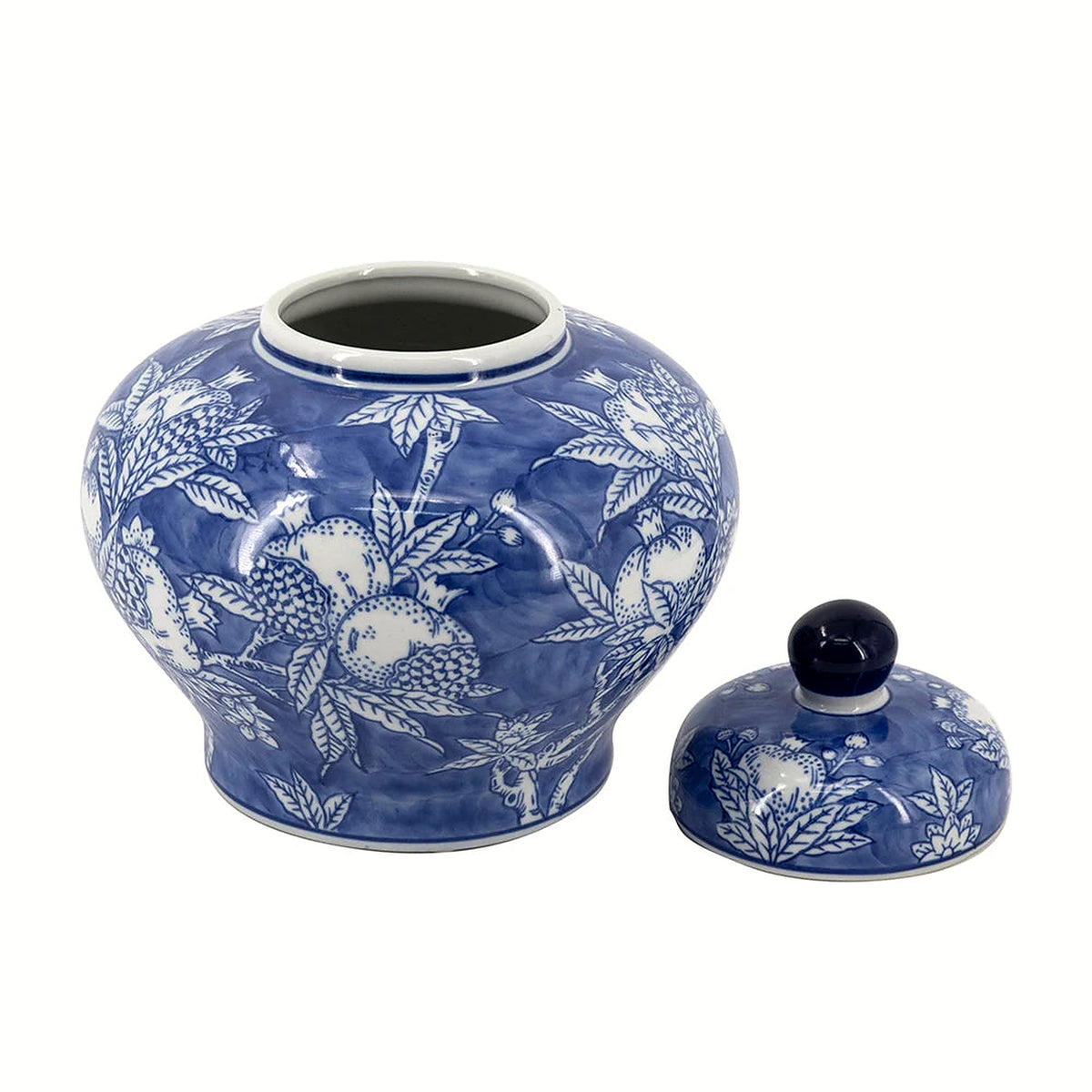Blue and white porcelain ginger jar with its domed lid set alongside, hand-painted with pomegranates and leaves