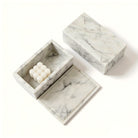 Open Carrara marble vanity box holding toiletries on a bathroom counter (toiletries and décor shown for styling)