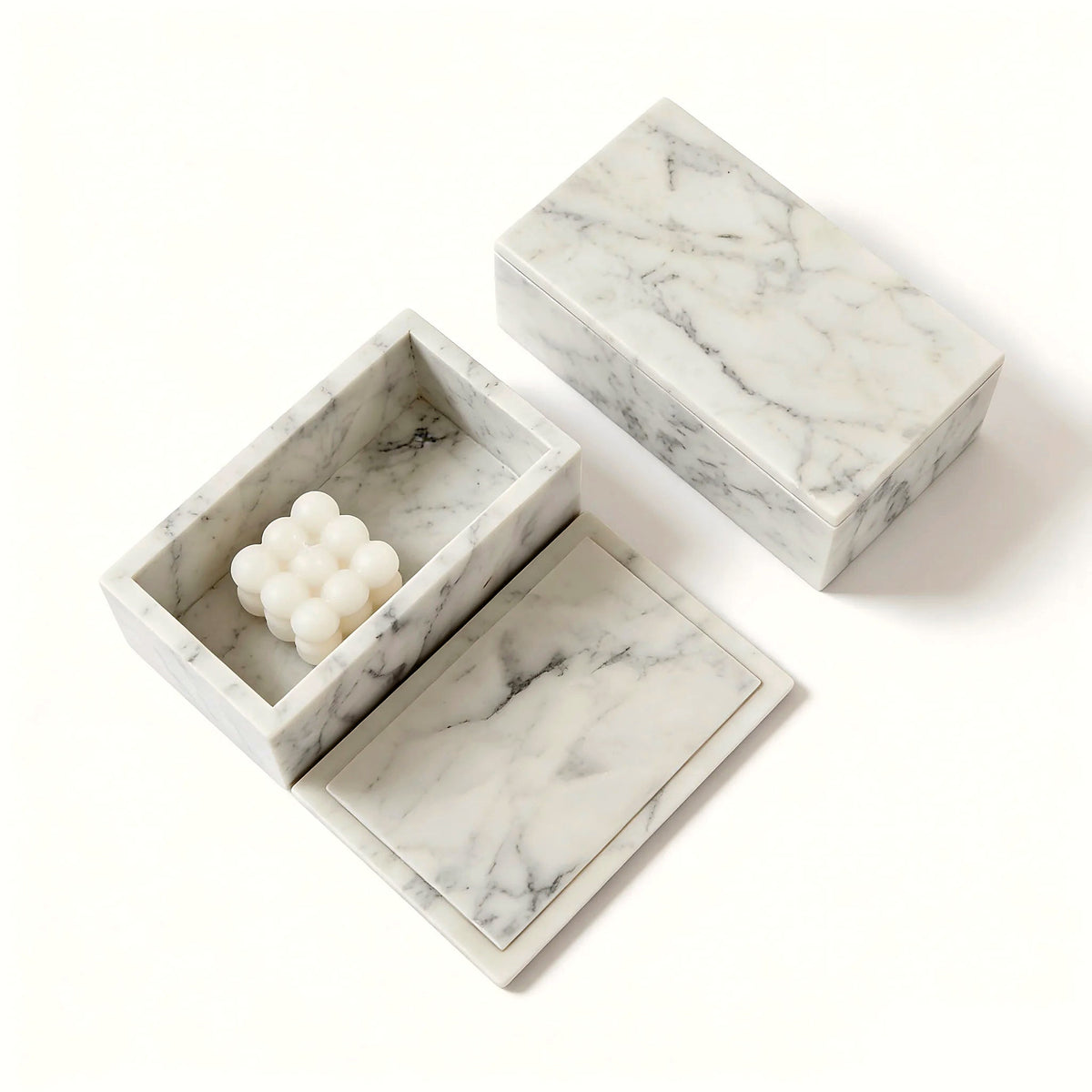 Open Carrara marble vanity box holding toiletries on a bathroom counter (toiletries and décor shown for styling)