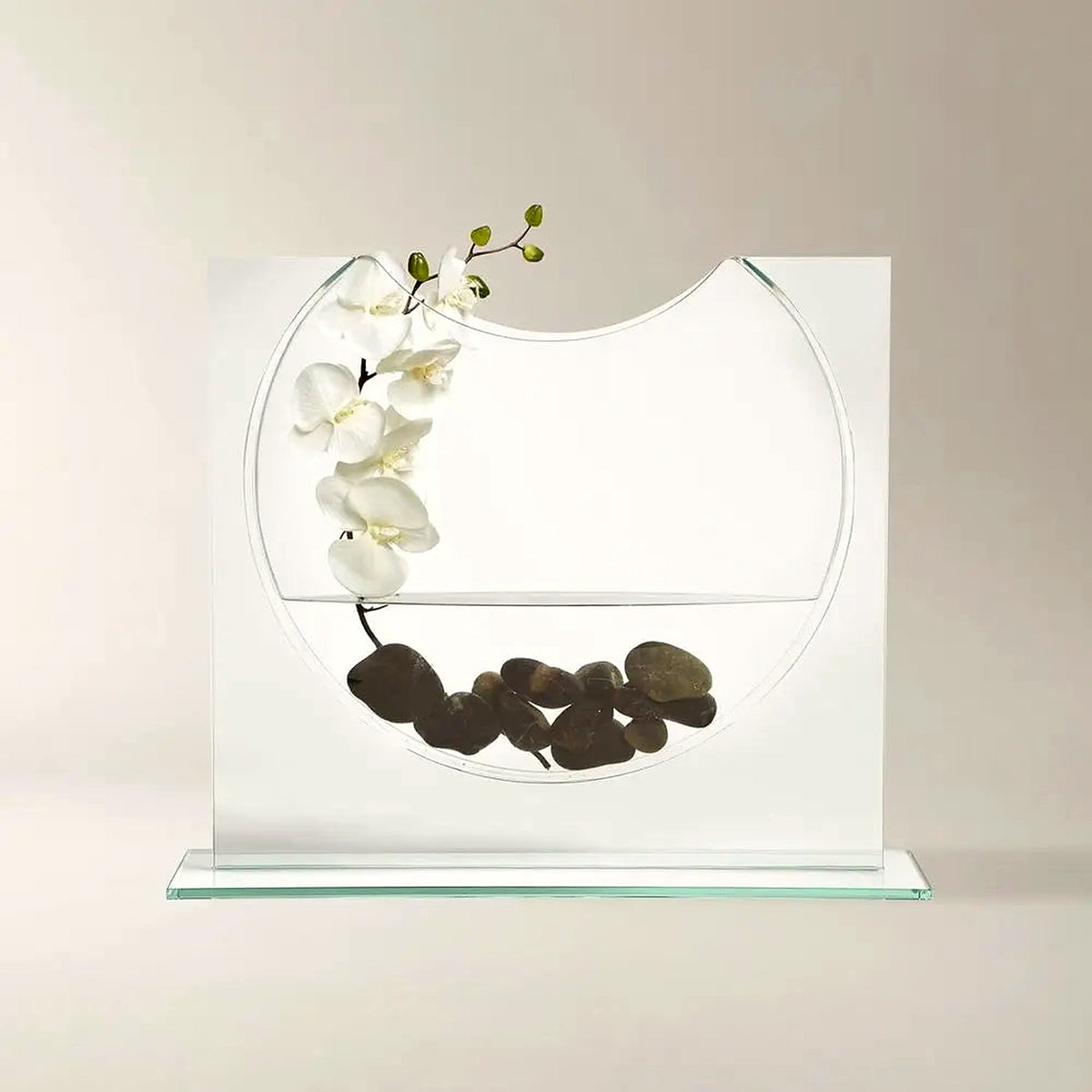 Clear glass ellipse vase with a white orchid and black river stones (orchid and stones shown for styling)