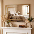 Gold beaded rectangular mirror hung horizontally above a white fireplace mantel (bedding, vases and décor shown for styling)