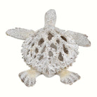 Top view of the openwork coral-pattern shell on the white sea turtle sculpture