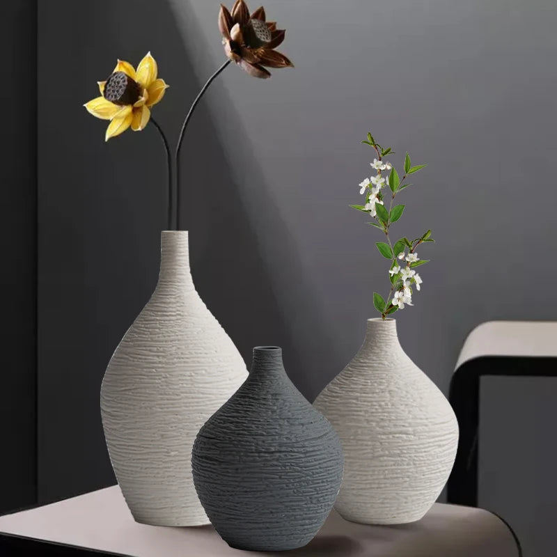 Beige and grey textured ceramic bud vases holding single stems