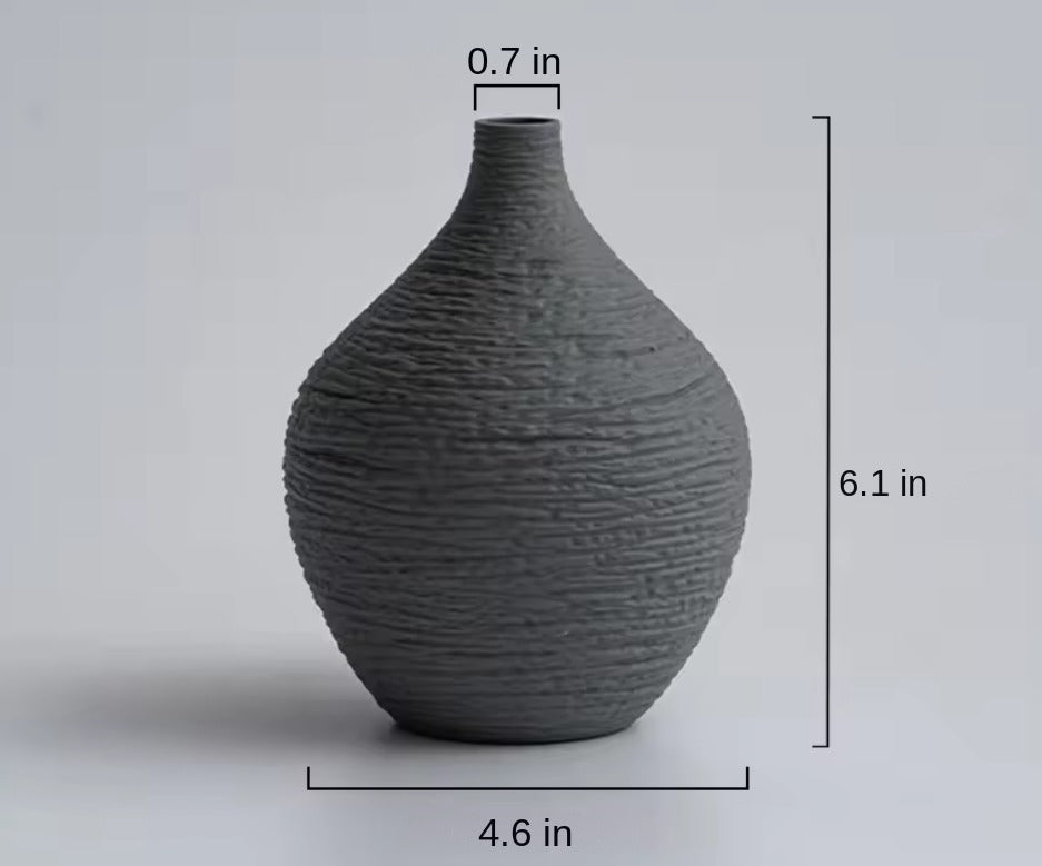 Small grey textured ceramic bud vase with size labels in inches