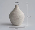 Small beige textured ceramic bud vase with size labels in inches