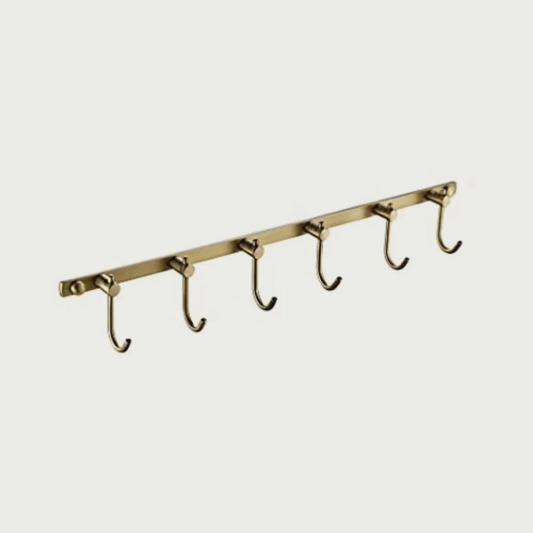 Slow cinematic tour of the brushed brass six-hook towel rail from real product photography