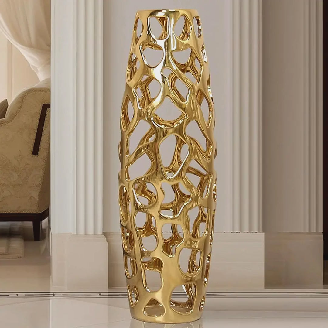 Slow cinematic tour of the gold openwork ceramic floor vase, including a scale view held by a model