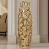 Slow cinematic tour of the gold openwork ceramic floor vase, including a scale view held by a model