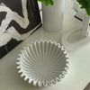 Slow cinematic tour of the white pleated ceramic centerpiece bowl from real product photography