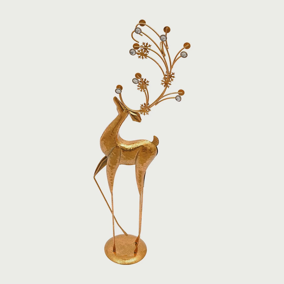 Slow cinematic tour of the gold metal deer sculpture with faux crystal accents from real product photography