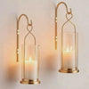 Slow cinematic tour of the gold hurricane candle wall sconces, mounted and styled on a table