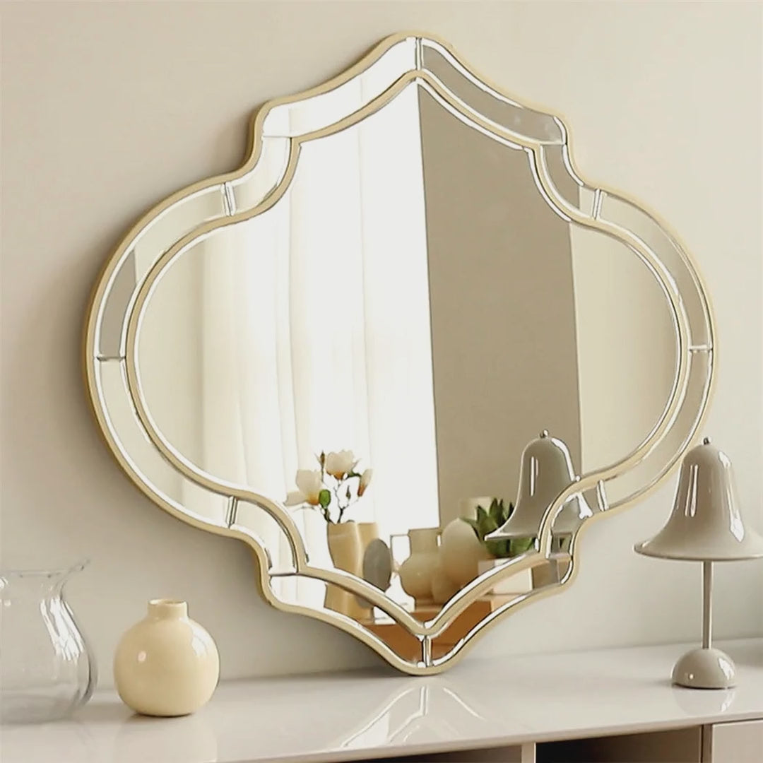 Slow cinematic tour of the gold-rimmed quatrefoil wall mirror from real product photography